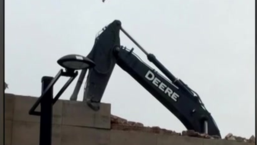 John Deere excavator falls though roof at Halifax demolition site