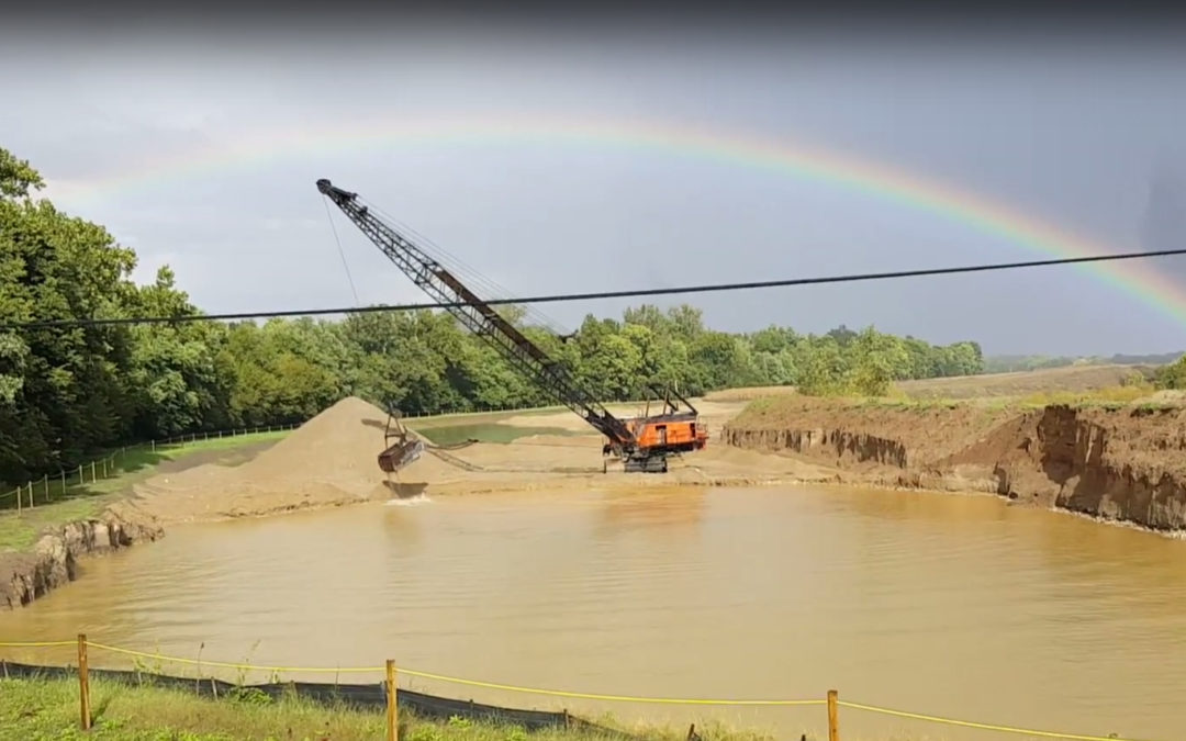 A dragline crane works under a rainbow in this Video