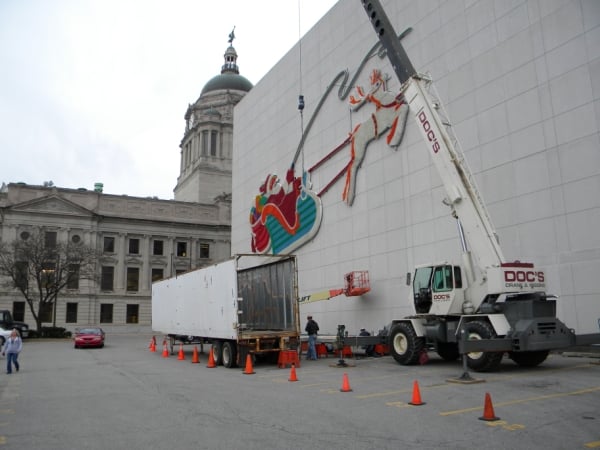 Doc’s Crane & Rigging works on assembling and installing the iconic Santa Claus and reindeer light display in downtown Fort Wayne.