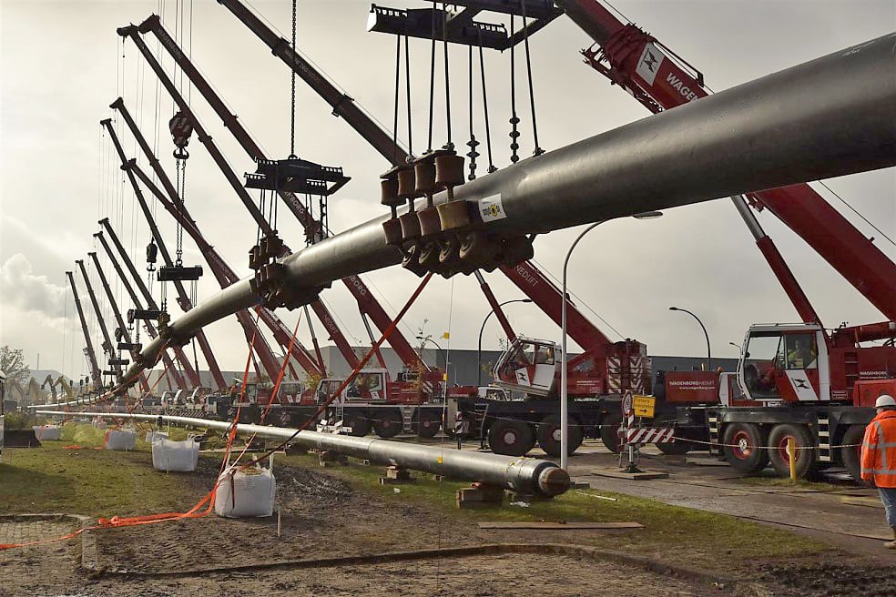 14 Wagenborg All Terrain Cranes line up to lift up two pipes that will run under a canal in the Netherlands