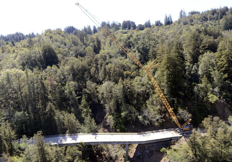 Construction crews use a wrecking ball to dismantle the Pfeiffer Canyon Bridge on Highway 1 in Big Sur, Calif. on Monday March 15, 2017. The bridge was compromised after slides occurred in the area associated with this winter's heavy rains. (David Royal - Monterey Herald)