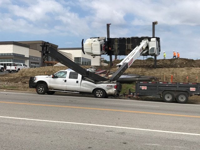 An Elliott boom truck crane tips over in Blue Springs, Missouri
