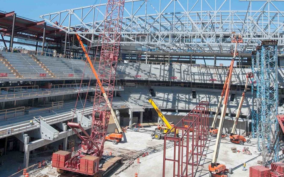 Two Manitowoc 16000 crawler cranes raise the roof at the Milwaukee Bucks new Stadium