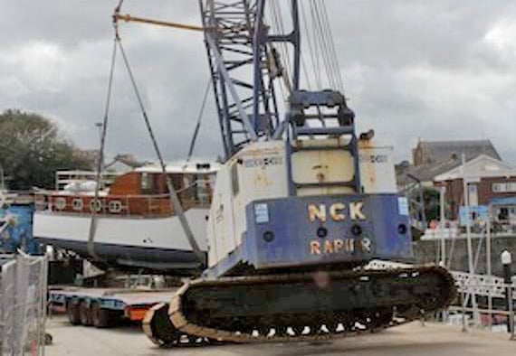 NCK Rapier crawler crane working dockside tipped off it’s crawler tracks lifting a boat